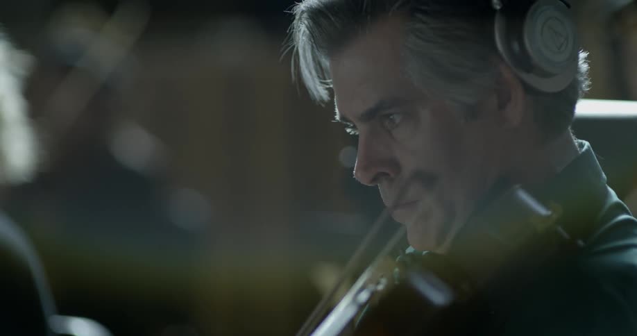 Man in orchestra playing the violin