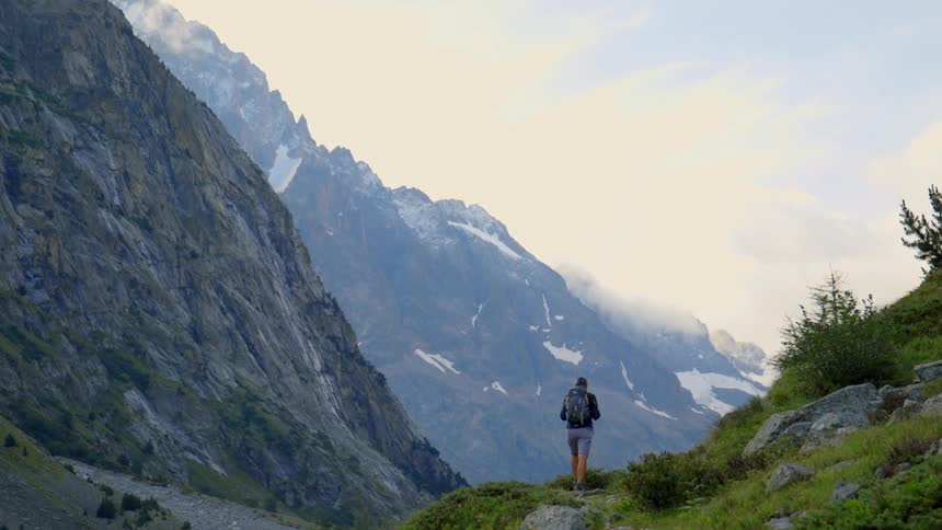 Man hiking on trail in the mountains