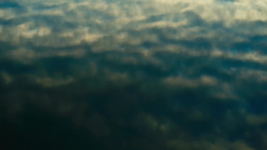 Ocean water reflecting the sky on its surface at midday