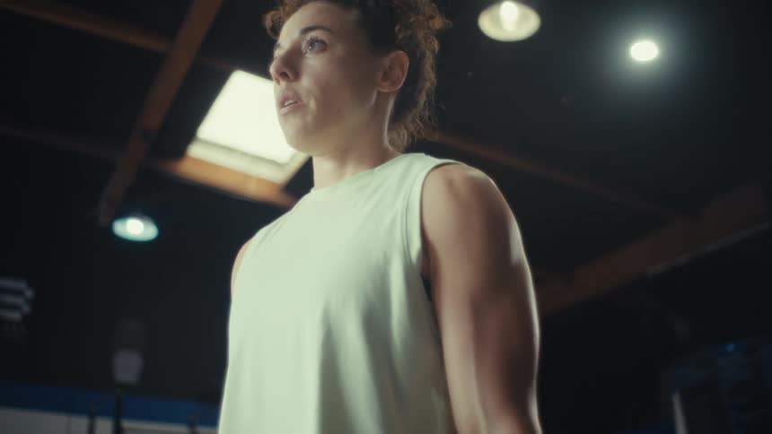 Young woman exercises lifting dumbbell weights with both hands