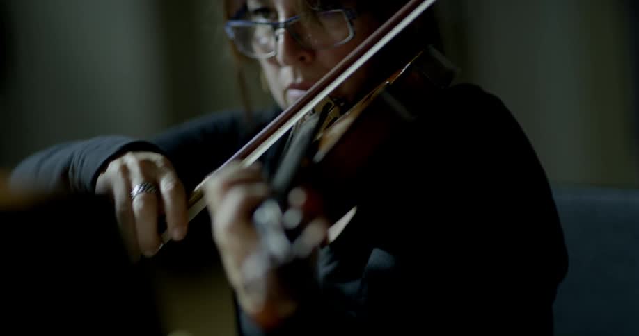 A woman plays a violin