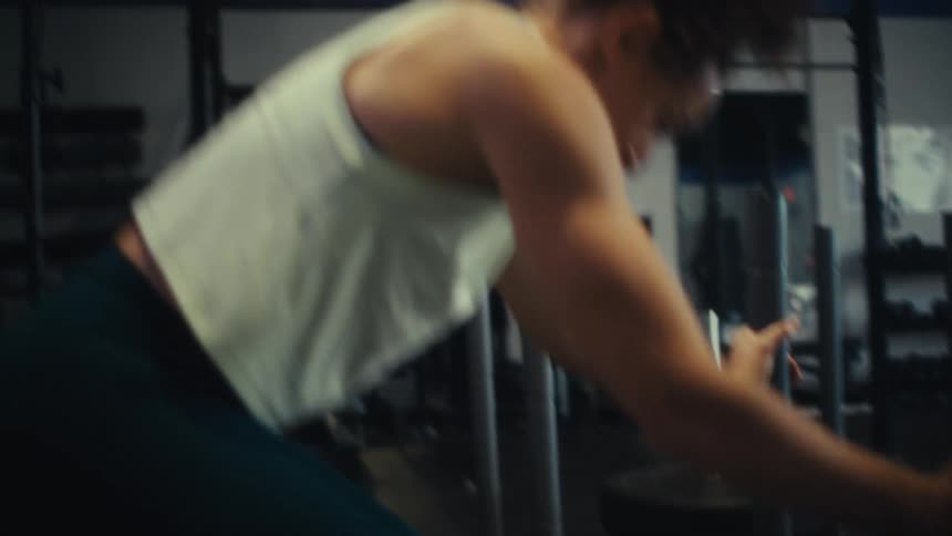Woman performs rope exercise in a gym setting