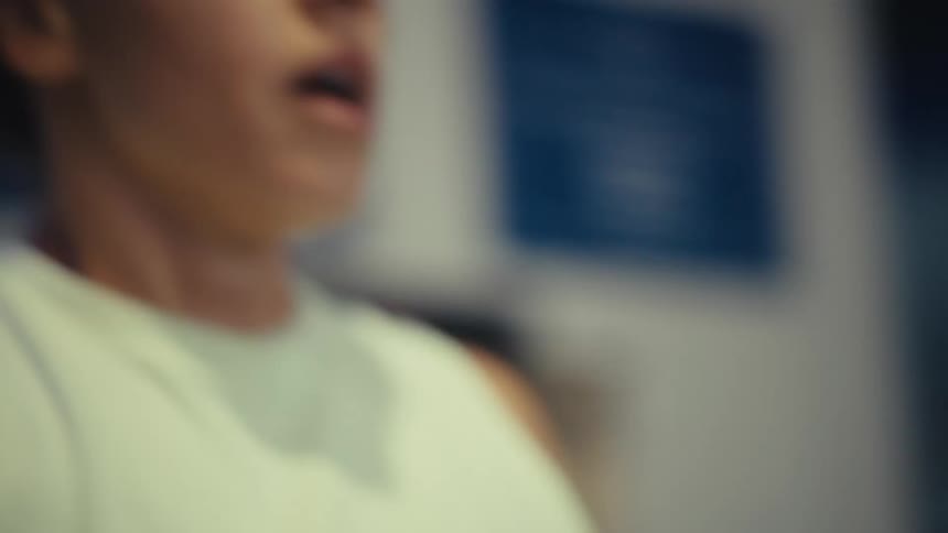 A young woman in the gym catching her breath after an intense workout