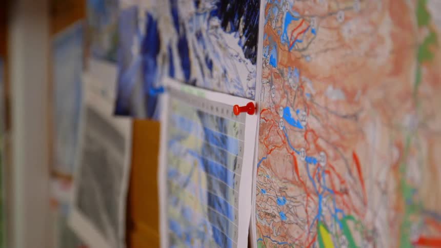 Maps pinned to a bulletin board