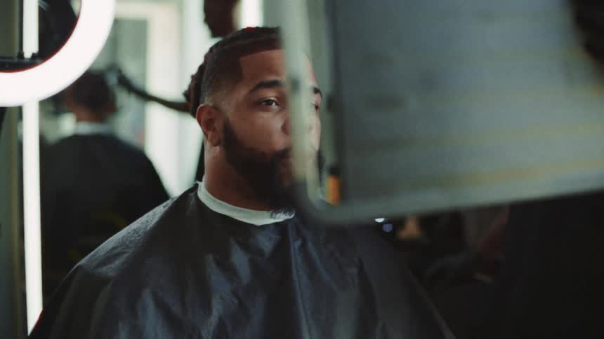 Man gets a haircut with clippers in a barbershop