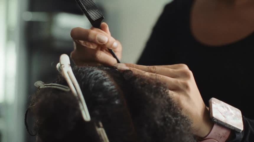 A woman doing hair in a room