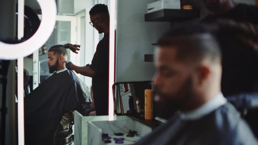 A man getting a haircut at a barber shop
