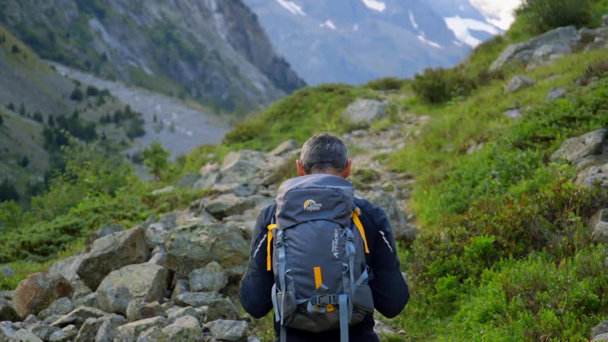 A man hikes a gravel path