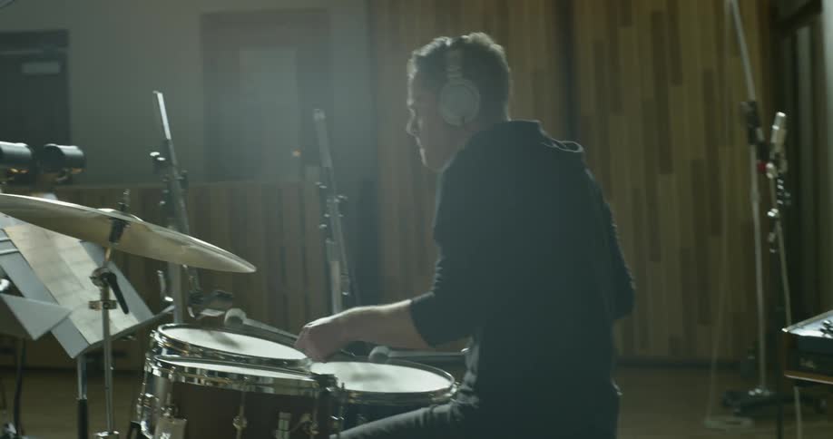 Man plays drums in a studio