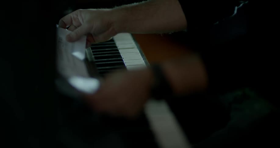 A man sits down to use a piano