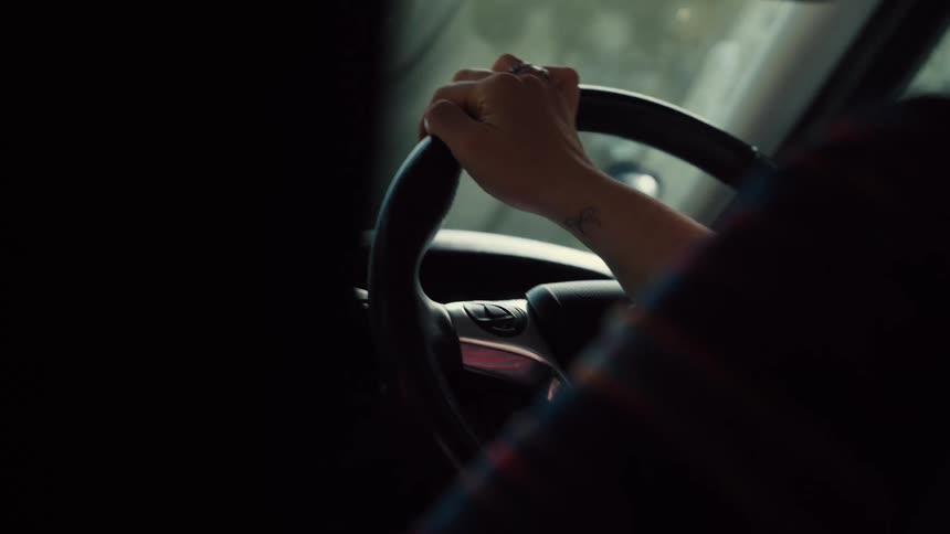 The woman is driving a car