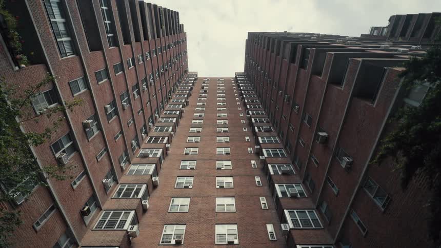 A highrise condo building with brownpainted walls at midday