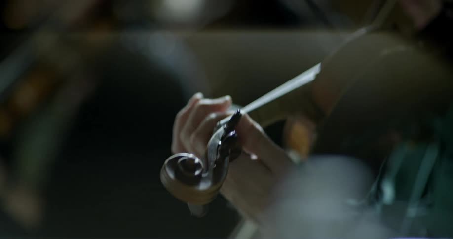 A person's moving hands as they play the violin