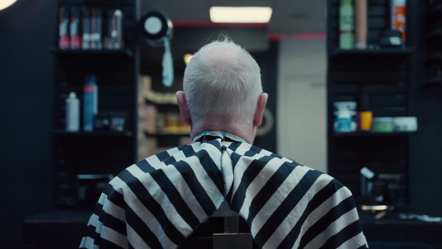 A man sitting in a barber shop