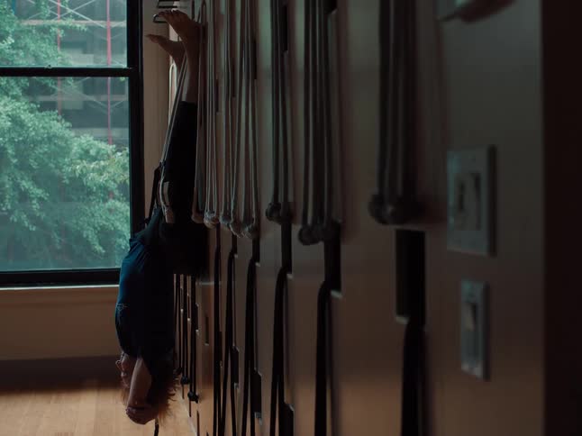 A woman stretching in a room