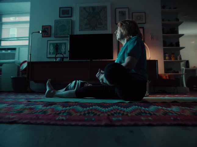 The woman does yoga in her living room