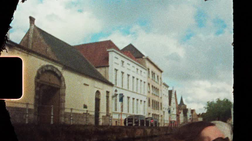 Historic facades lined along a street under a partly cloudy sky