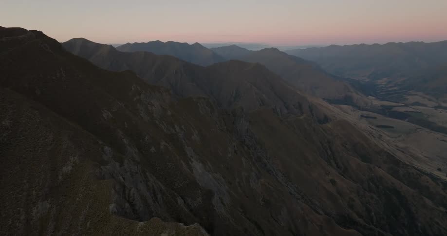 Rough terrain mountain range under a hazy sky