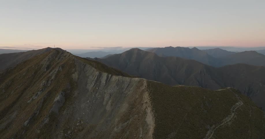 Mountain ridge with visible trails under an evening sky