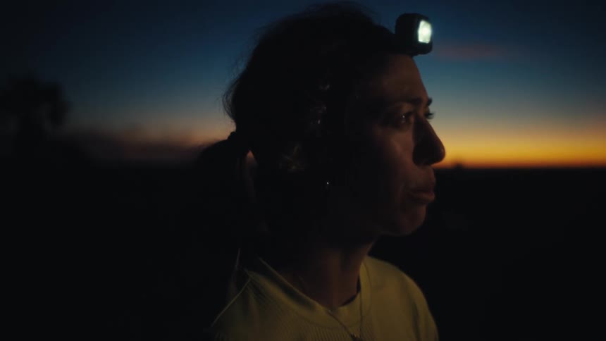 The woman watches the sunset in the desert