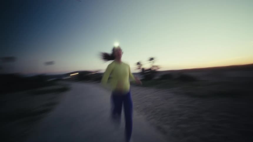The woman is running towards the building