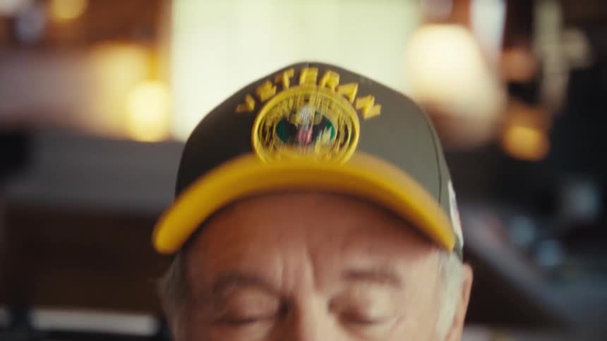 A man sitting in a room laughing