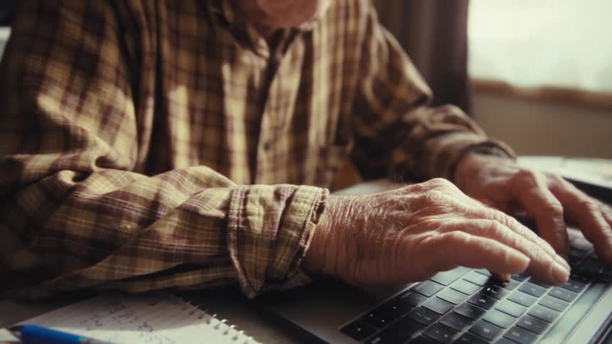 A man using a laptop in a room