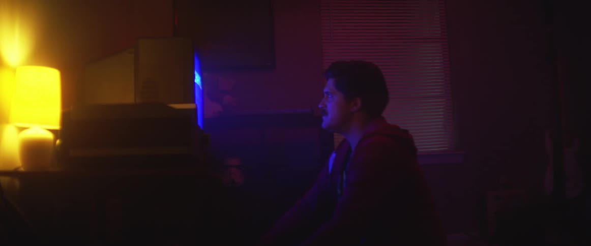 Man looking at a video screen in the dark