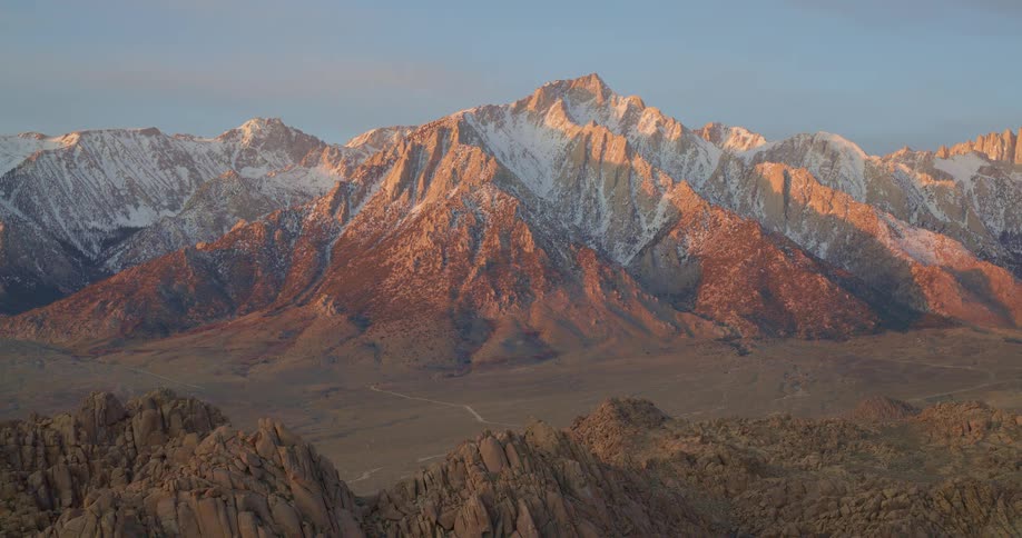 An aerial view of mountains covered in snow
