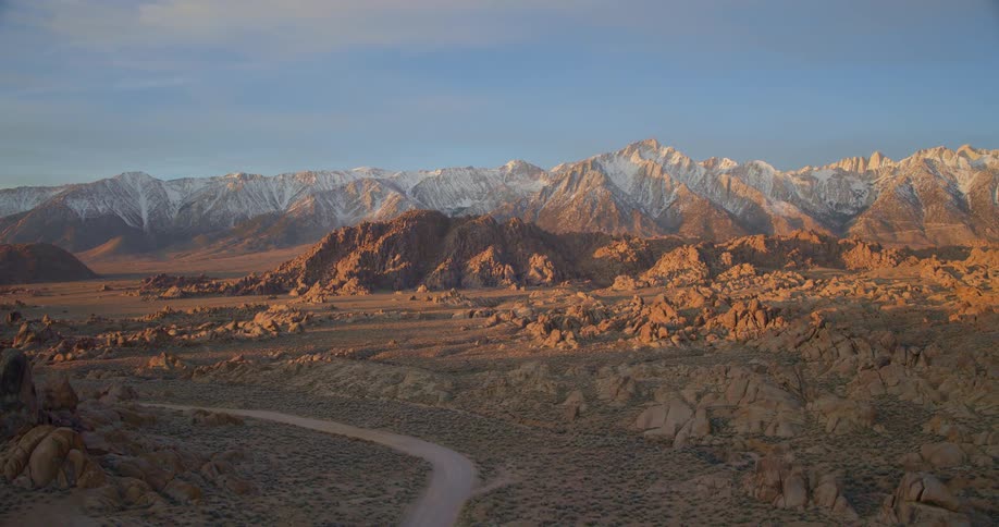 An aerial view of mountains with some snow on them