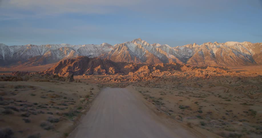An aerial view of a mountain range with snow on it