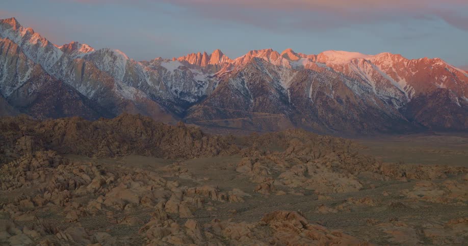 Aerial view of snowcapped mountains at dawn