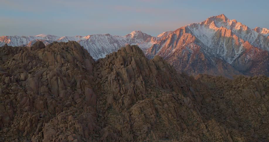 Rough terrain of rocky mountains and snow on mountains in the distance
