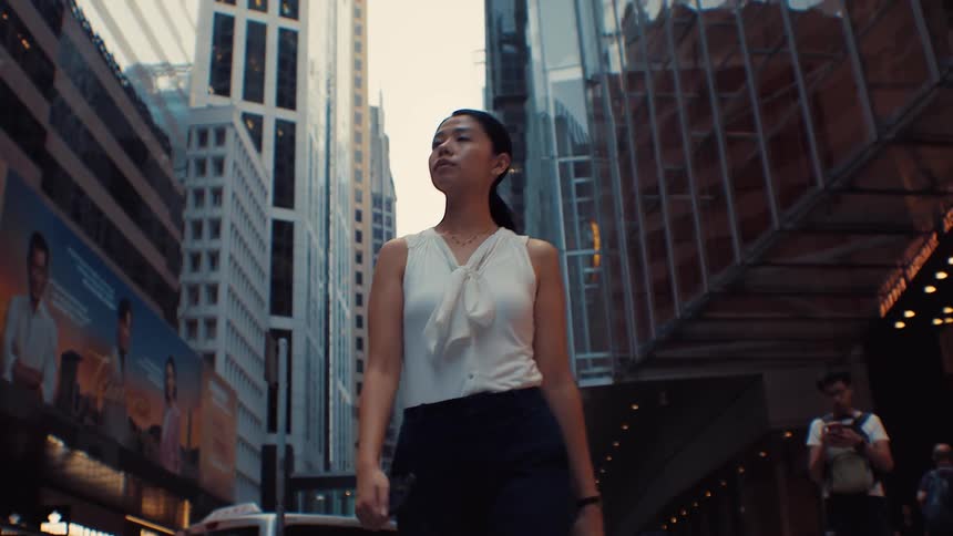 The woman is walking through the city