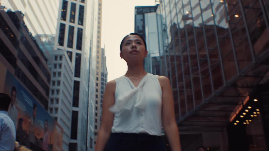 The woman is walking through the city