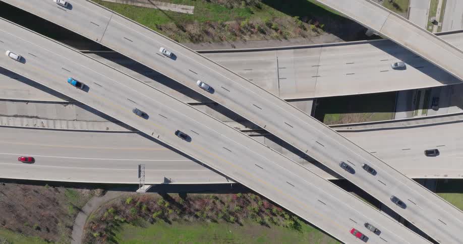 Traffic on a freeway moving over and under the roadway interchange