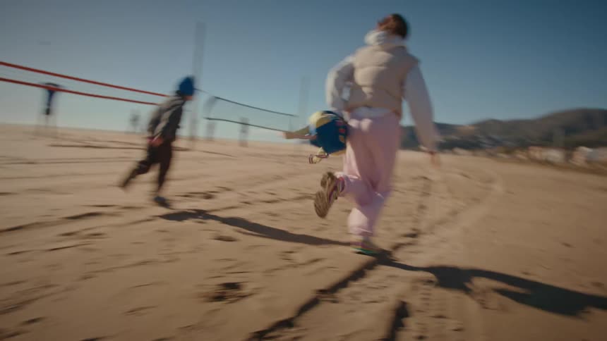 A woman running on the beach after her son