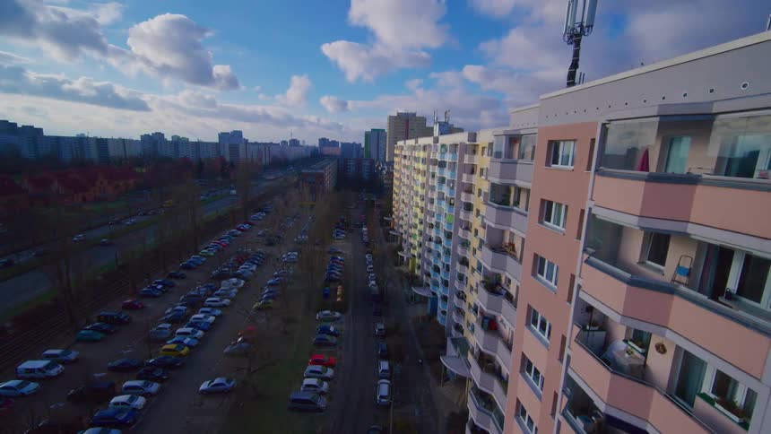 Aerial footage of a long row of residential apartment buildings in a city