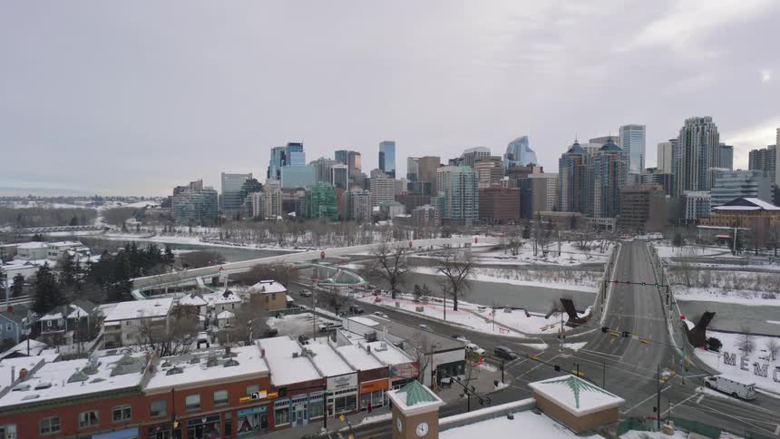 Urban landscape with highrise buildings river and snowcovered streets