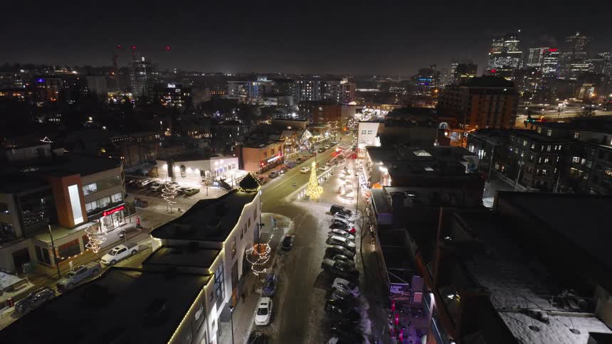 Cars drive down the city roads at night
