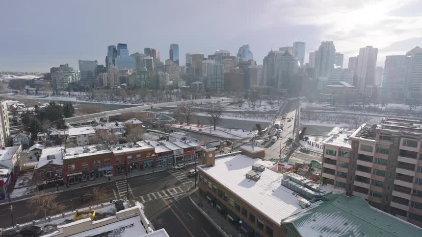 Pedestrians and vehicles move through the neighborhood across multiple bridges from downtown on a winter day