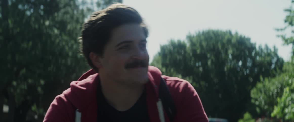 A man is riding a bike and smiling