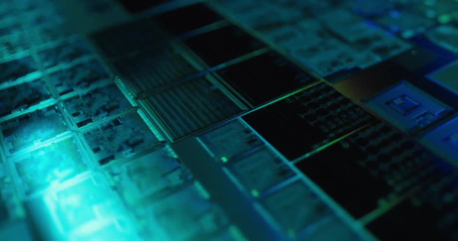 Microchip with modules and electronic components illuminated by bluishgreen light