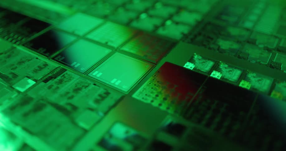 Closeup of reflective circuit board components that appear green