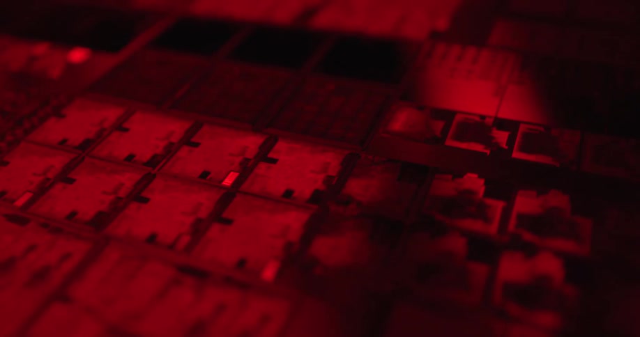 Microchip with modules and electronic traces illuminated by intense red light