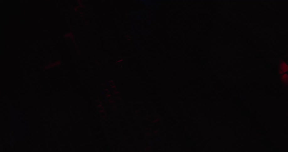 Microchip surface with electronic blocks and circuits illuminated in red blue and orange tones