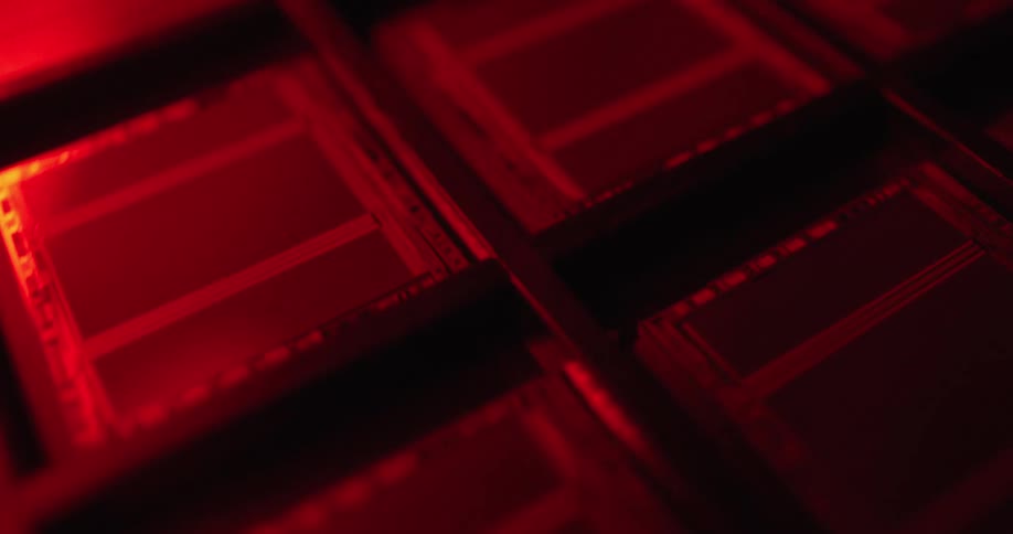 Microchip with aligned rectangular blocks under intense red lighting