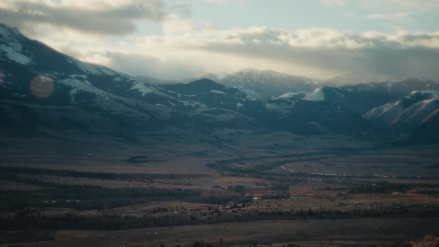 A view of a landscape with mountains in the distance