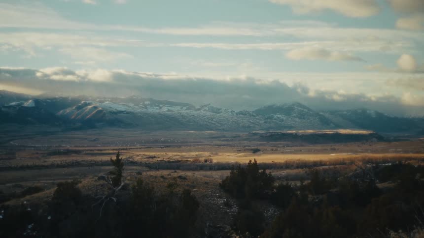 A view of a landscape with mountains in the distance