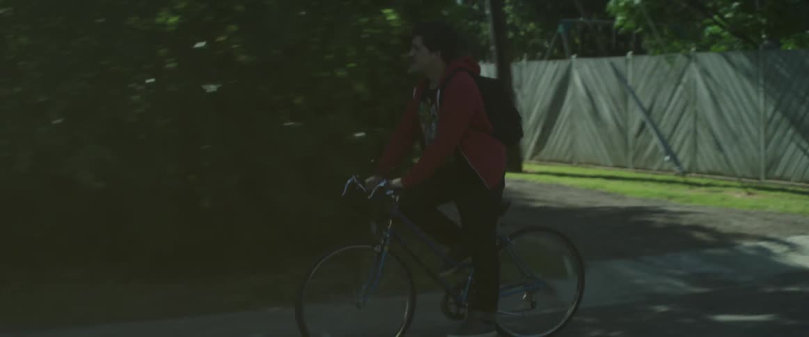Man rides a bike in a neighborhood